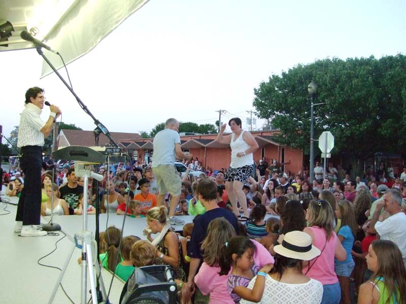 Photo of band performing and audience members dancing